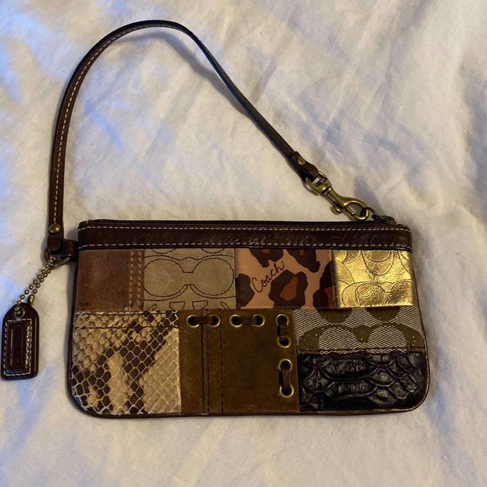 NWT Coach wristlet. Never used. Got as a gift and was not my style.